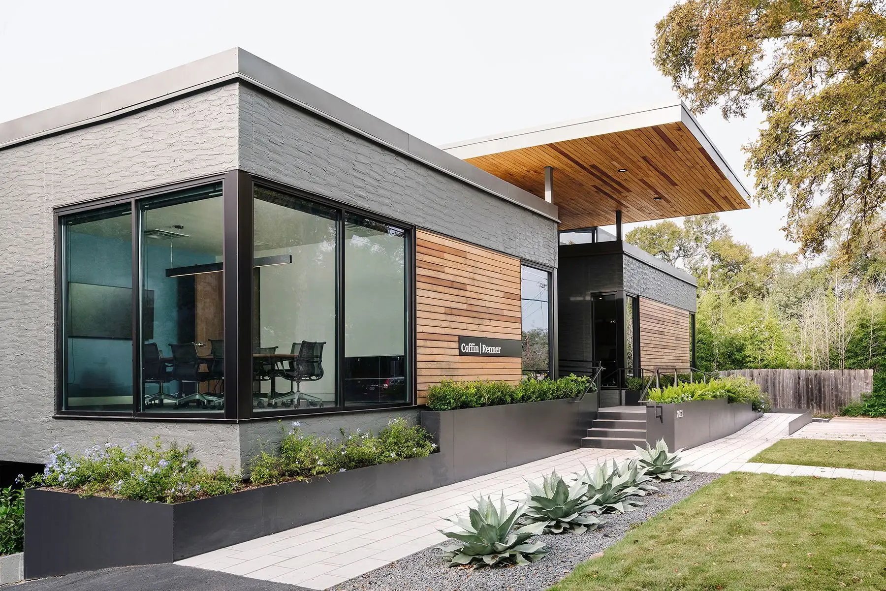 Office exterior with gray-painted brick, natural wood siding, and fresh finishes by an exterior painter in Barrhaven, ON